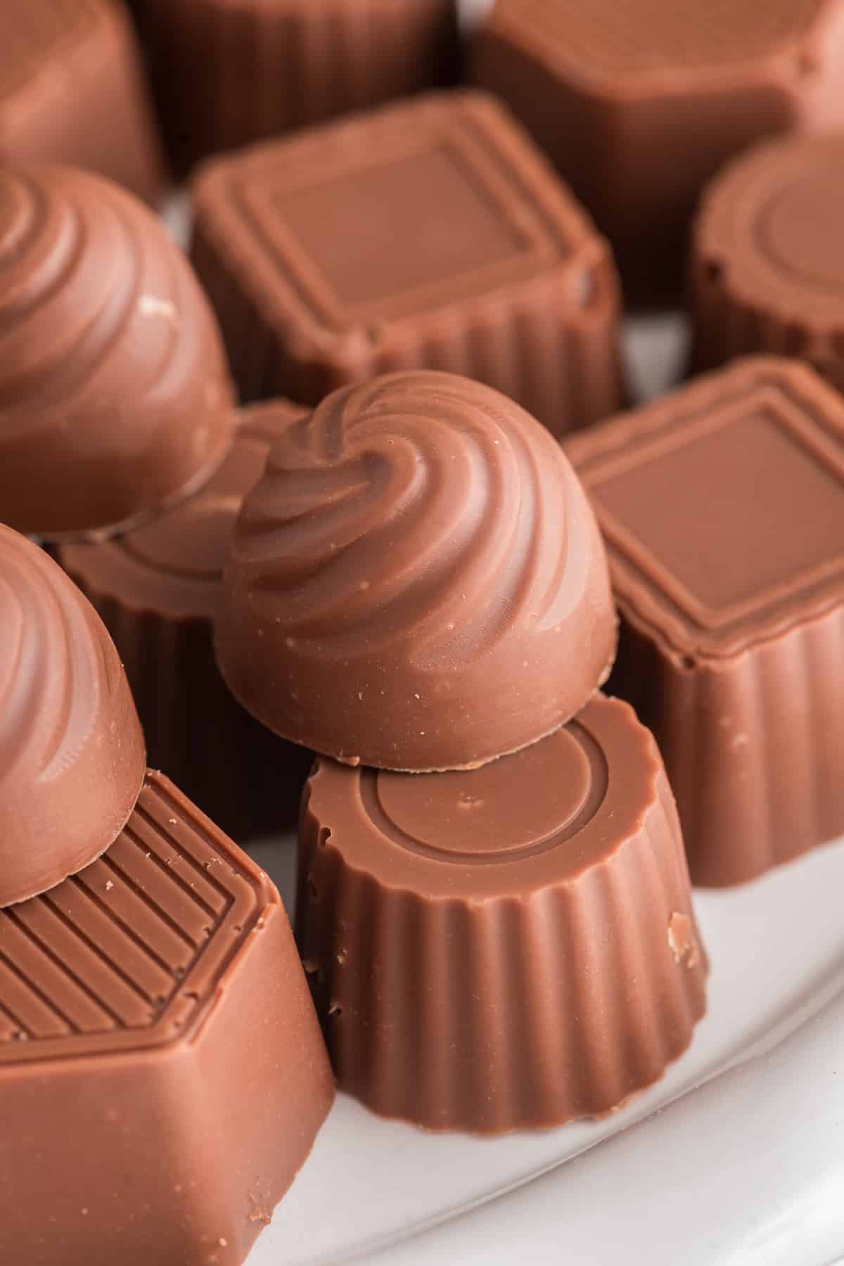 Chocolate mints on a white plate.