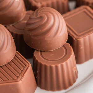 Chocolate mints on a white plate.