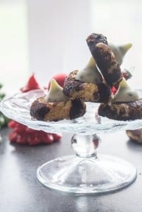 four cookies on a glass cake stand
