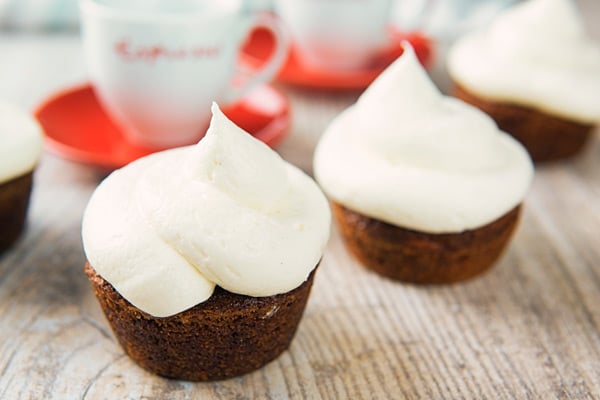2 carrot cake muffins with cream cheese frosting