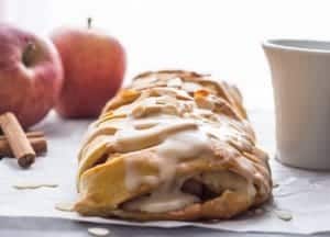 homemade apple strudel with maple glaze on parchment paper