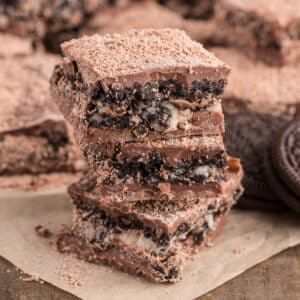 Three cookies and cream bars stacked.