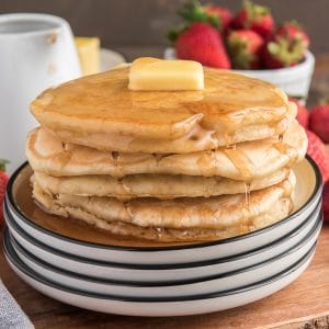 Pancakes stacked on a white plate.