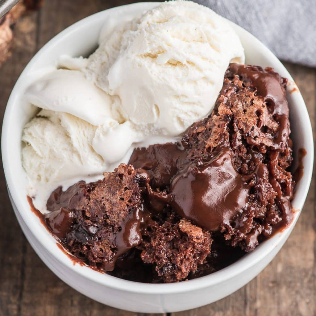 Cake in a bowl with some ice cream.