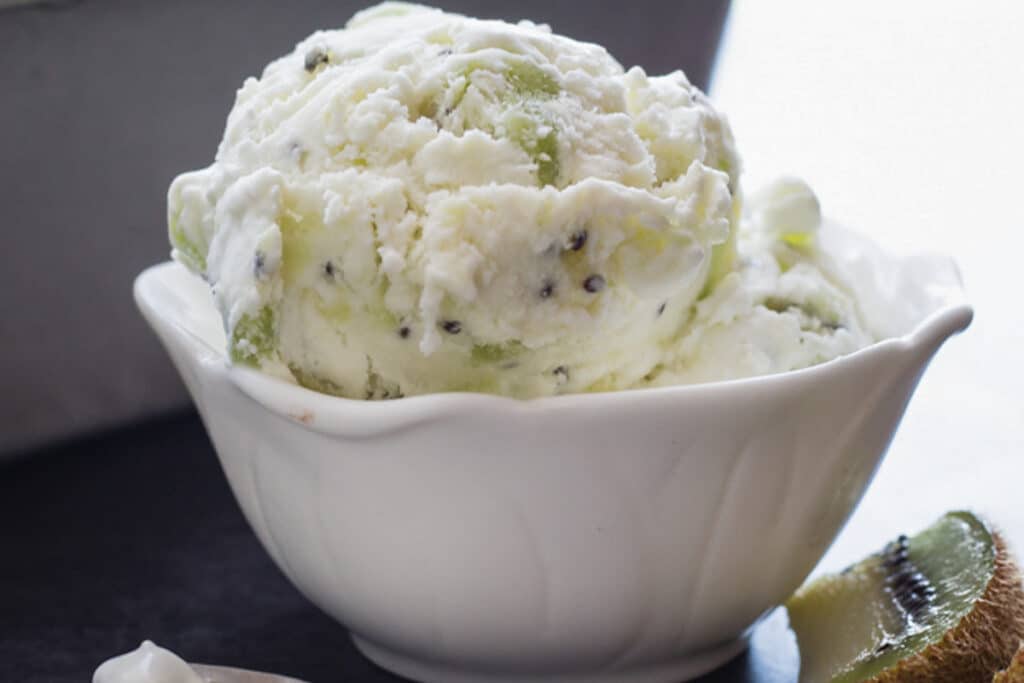 Kiwi ice cream in a white bowl.
