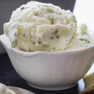 Kiwi ice cream in a white bowl.