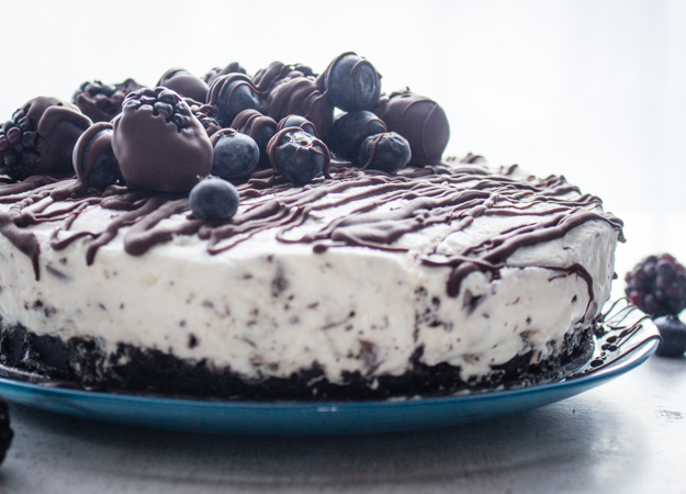 Light Cream Cheese Berry Cheesecake, a chocolate cookie crumb base and a creamy no bake chocolate chip filling. A delicious dessert recipe.