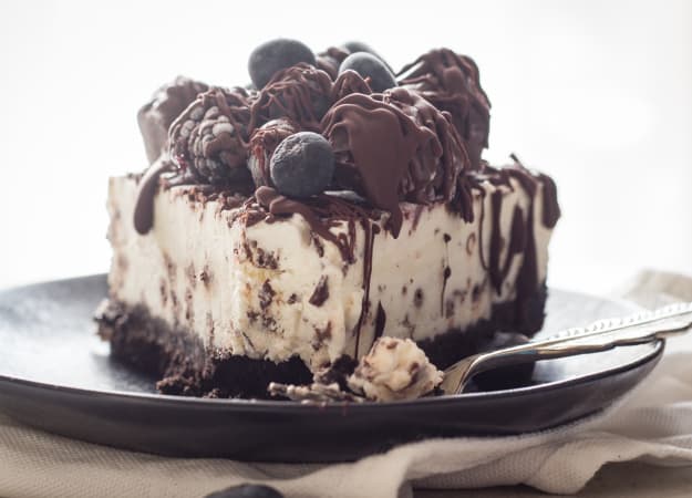 Light Cream Cheese Berry Cheesecake, a chocolate wafer base with a light cream cheese dark chocolate chip filling. a light and creamy no bake dessert.