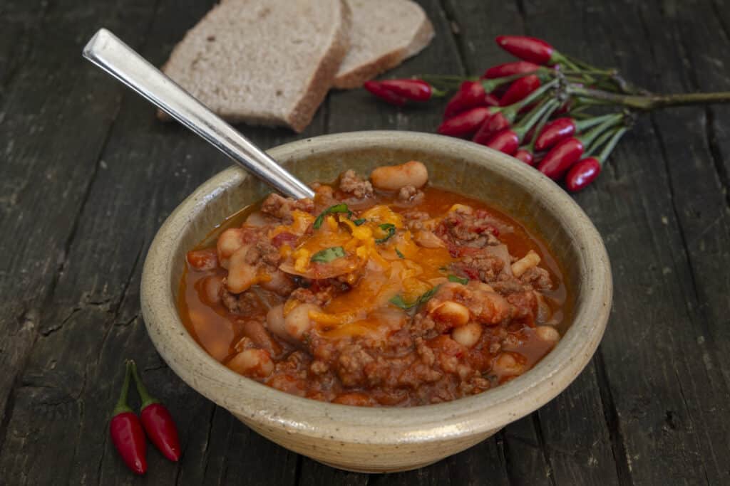 Cooked chili in a grey bowl.