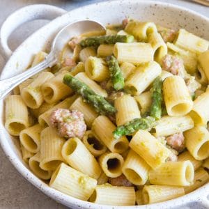 creamy asparagus pasta in a white baking dish