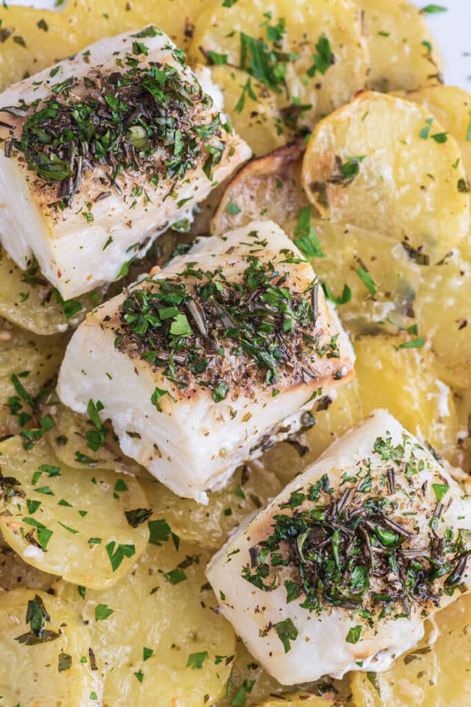 Three pieces of fish with potatoes.