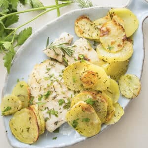 Fish and potatoes on a blue dish.
