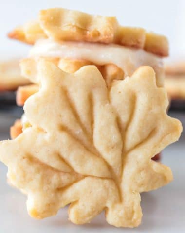3 maple leaf cookies stacked with one leaning against them