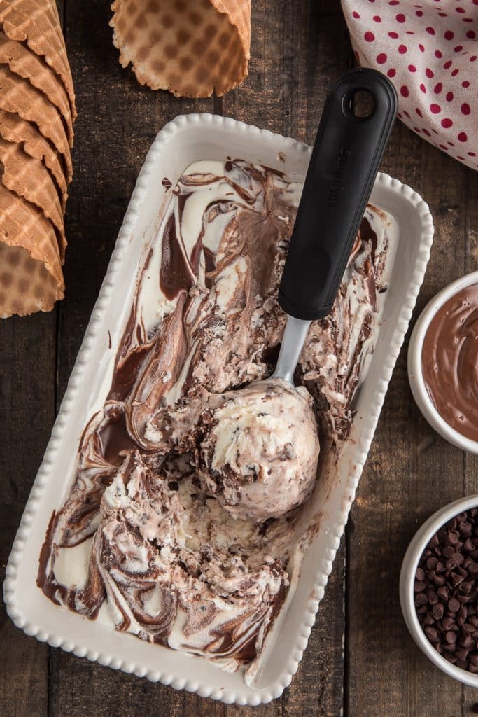 Nutella ice cream in a white loaf with a scoop.