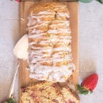 strawberry bread on a board with two slices cut