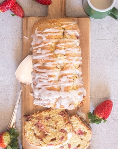strawberry bread on a board with two slices cut