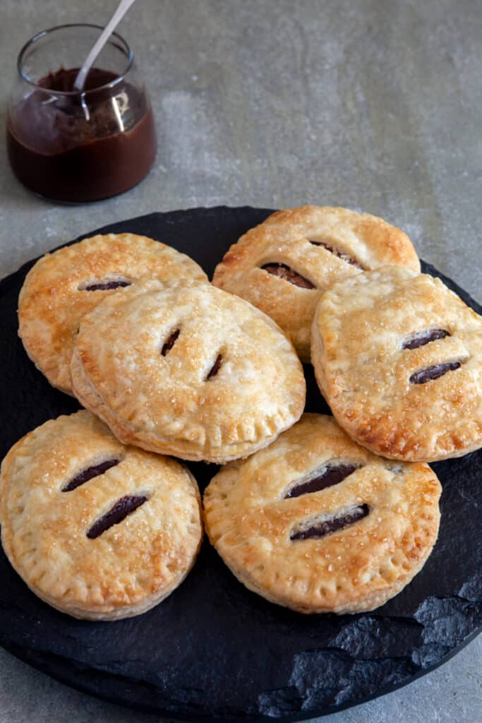 Nutella hand pies on a black plate.