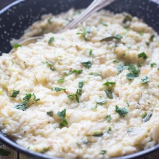 zucchini risotto in a black pan