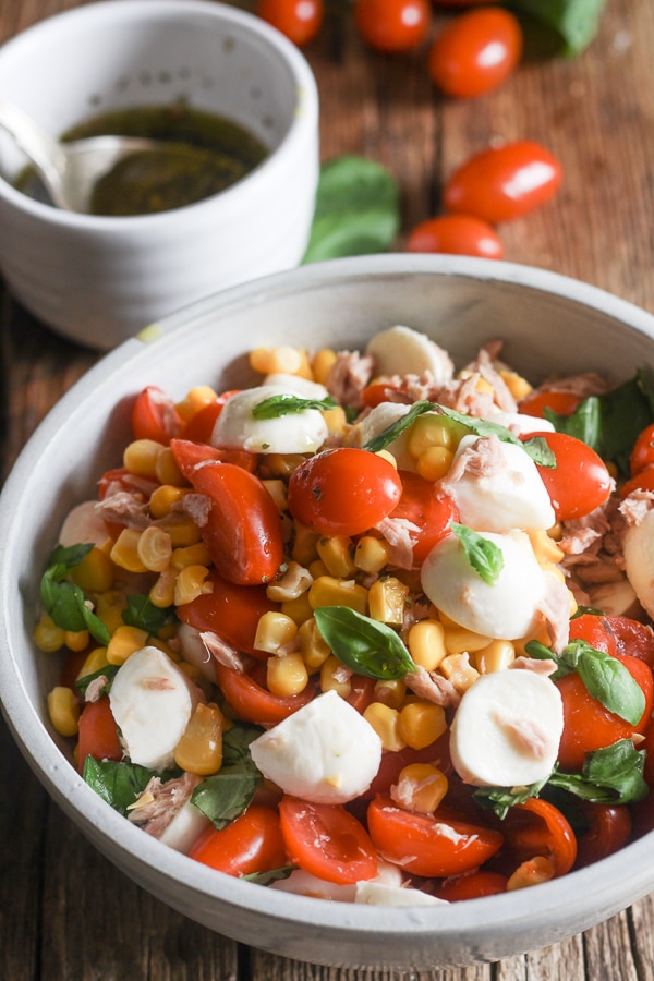 corn salad and dressing in bowls