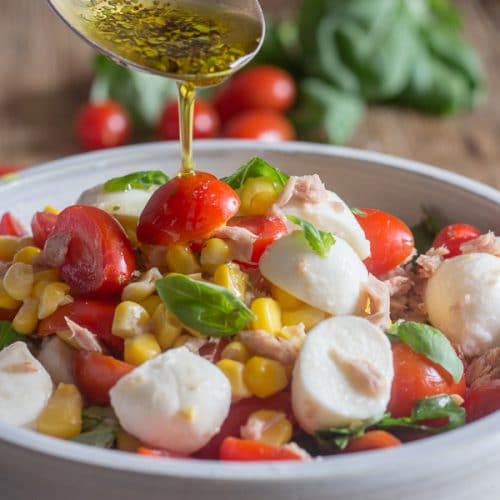 pouring dressing into corn salad