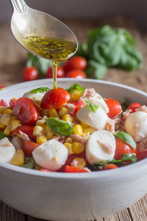 pouring dressing into corn salad