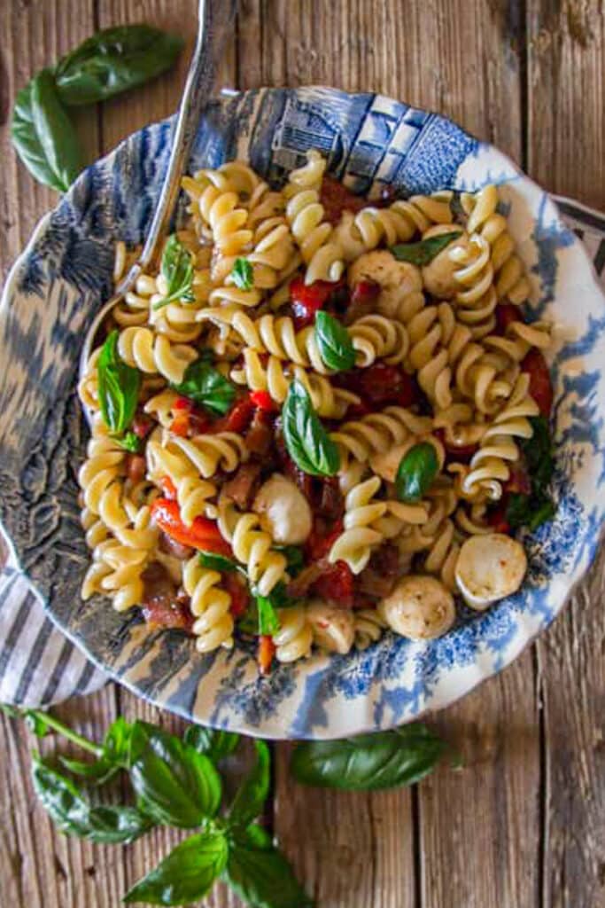 Pasta salad in a blue bowl.
