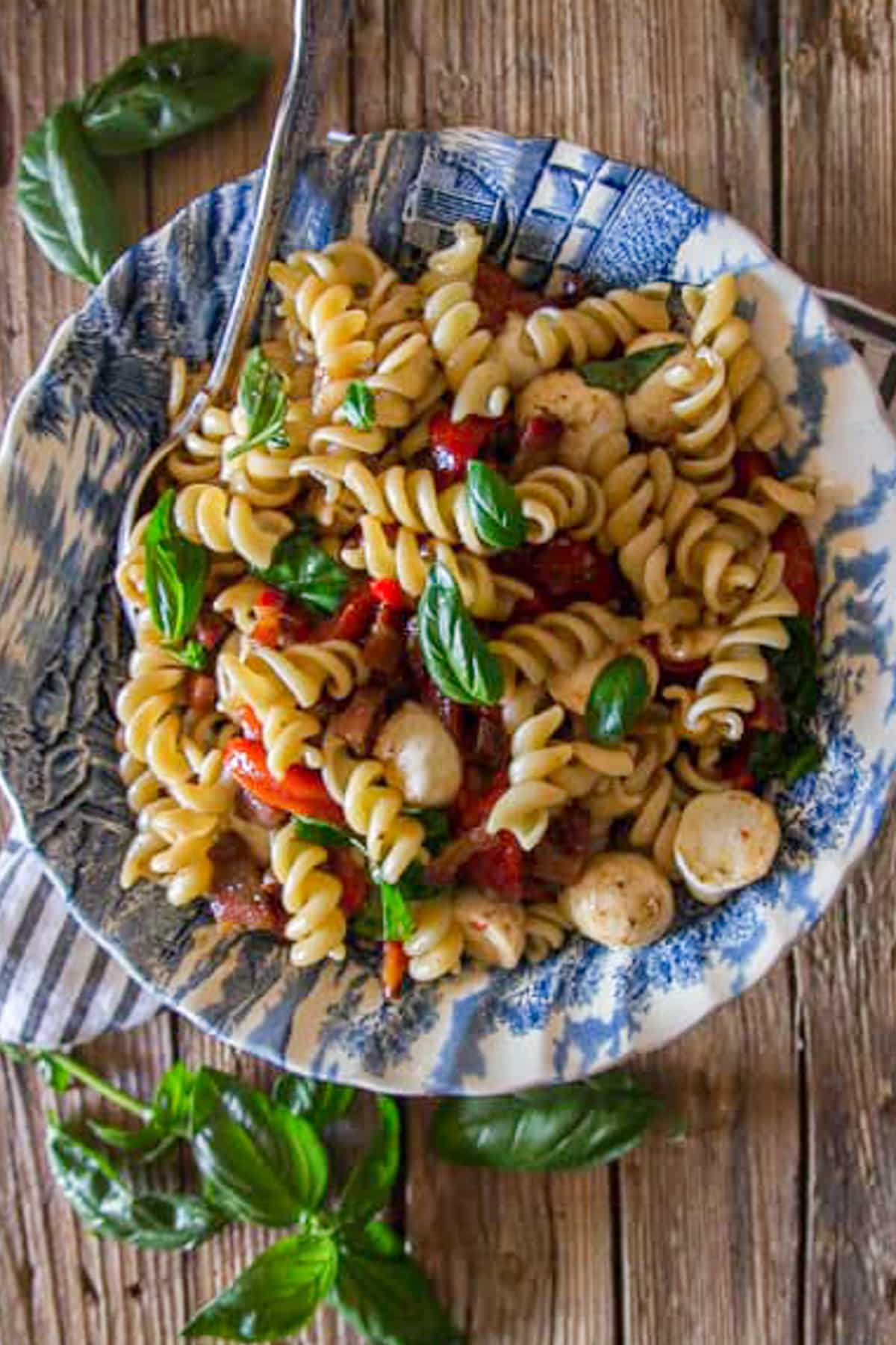 Pasta salad in a blue bowl.
