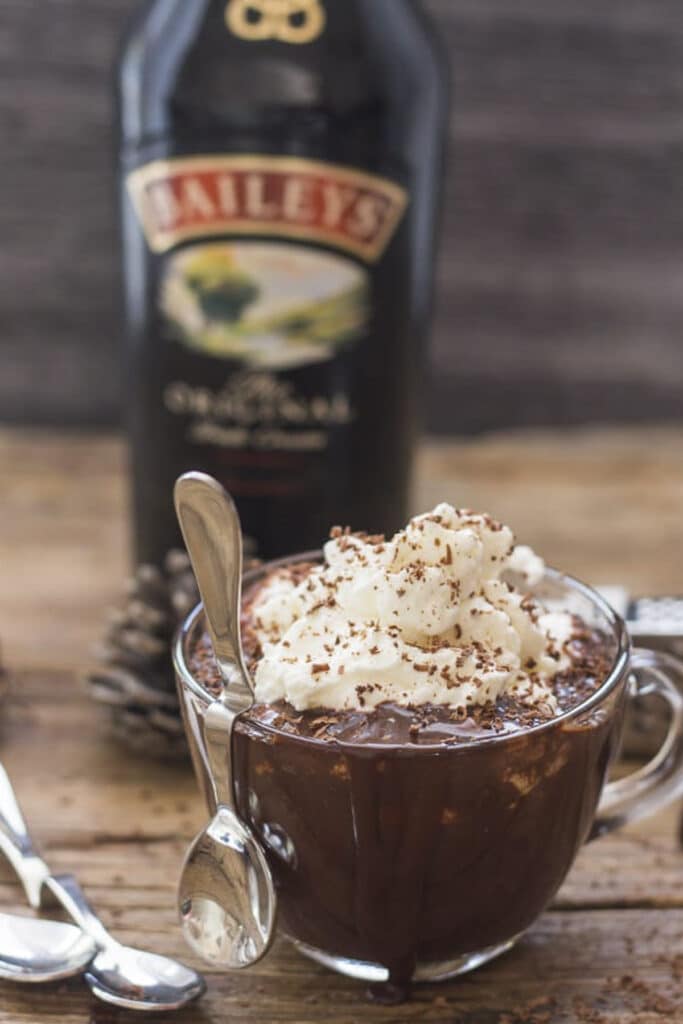 Baileys hot chocolate in a glass cup.