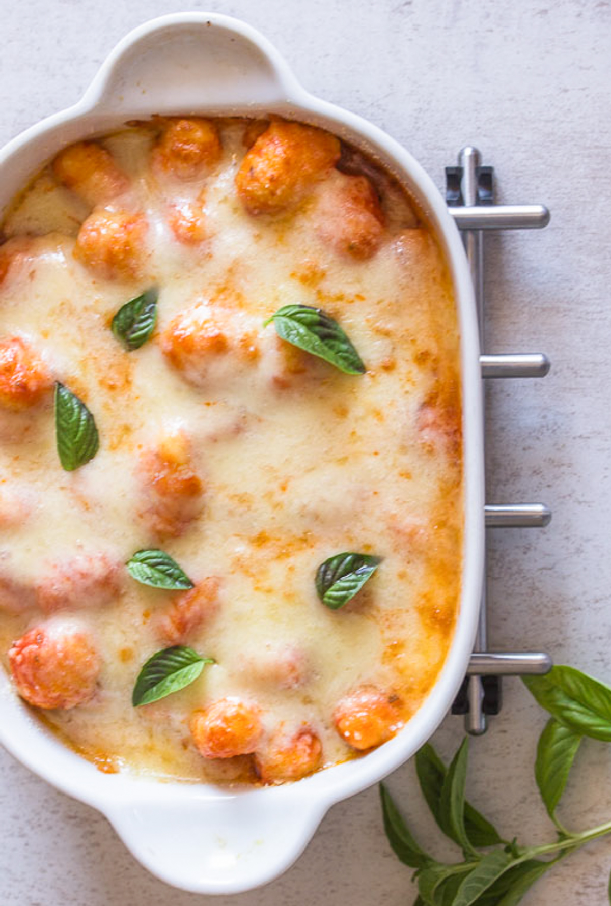 Baked gnocchi in a white dish.