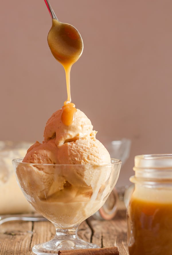 drizzling caramel sauce on easy homemade pumpkin gelato in a glass bowl