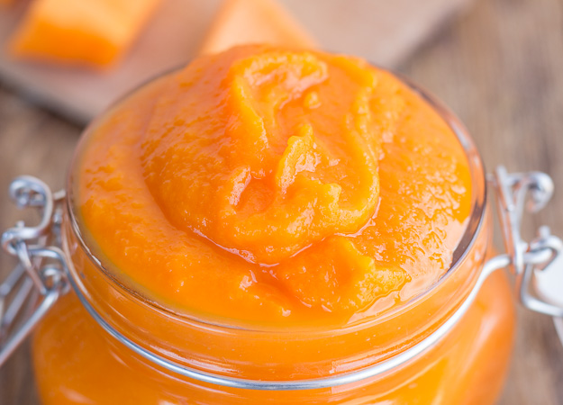 close up pumpkin puree in a glass jar