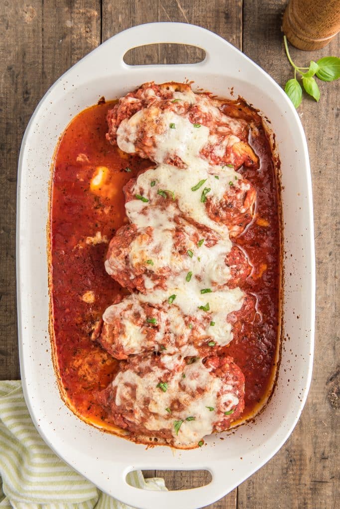 Chicken parm in a white pan.