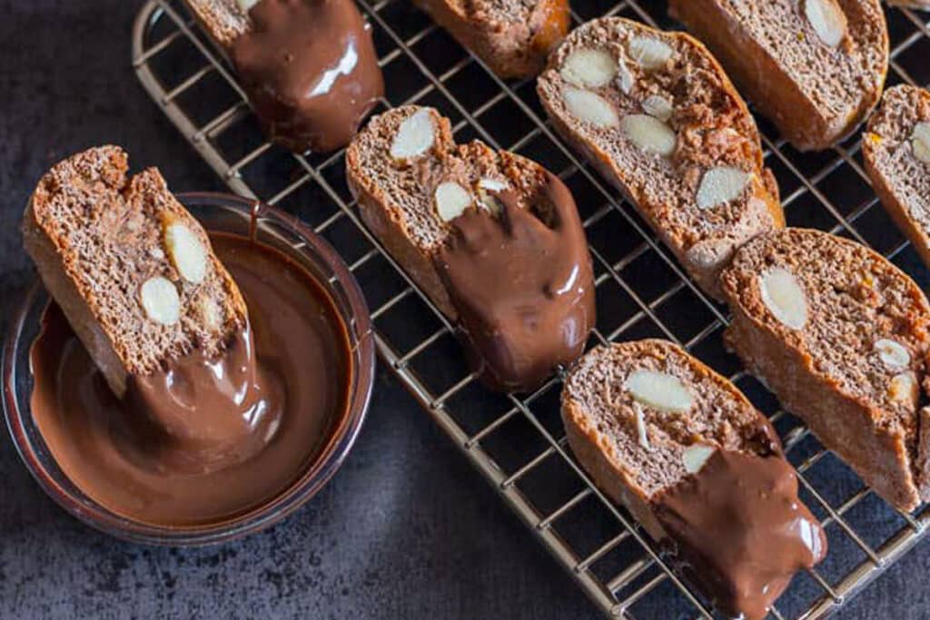 Biscotti on a wire rack and dipped in chocolate.