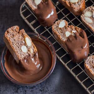 Biscotti on a wire rack and dipped in chocolate.