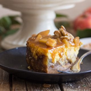 a slice of maple caramel apple cheesecake on a black plate