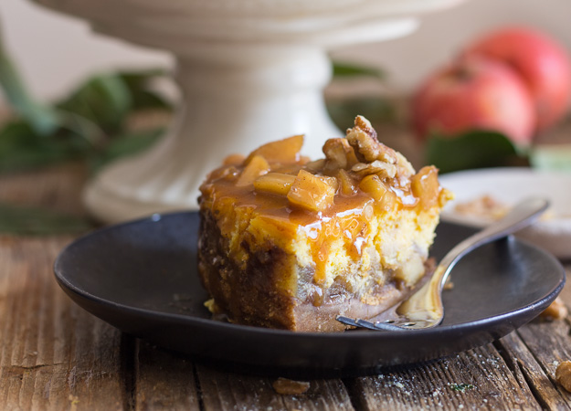 a slice of maple caramel apple cheesecake on a black plate