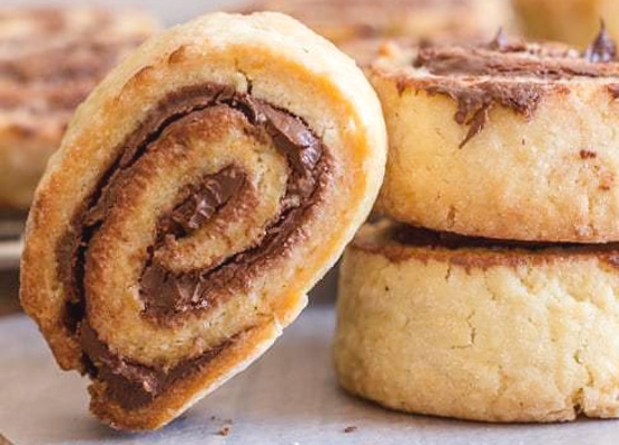 nutella pinwheel cookies one leaning on two stacked
