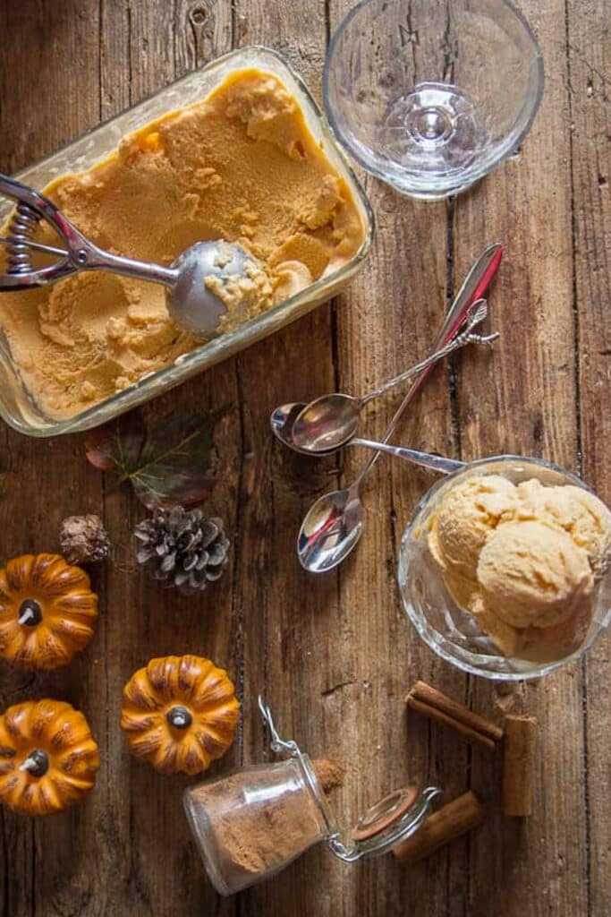 Pumpkin ice cream in a loaf pan and some in a bowl.