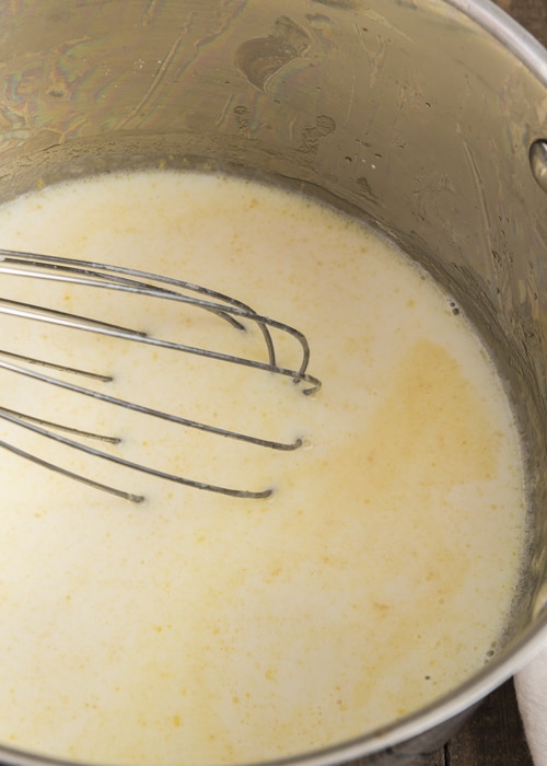 Making the white sauce in a pan.