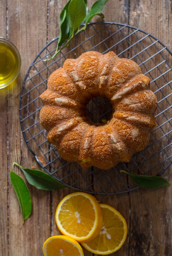 Orange Olive Oil Cake, a moist Italian Cake made with fresh oranges, olive oil and greek yogurt. A simple orange glaze makes it perfect. 
