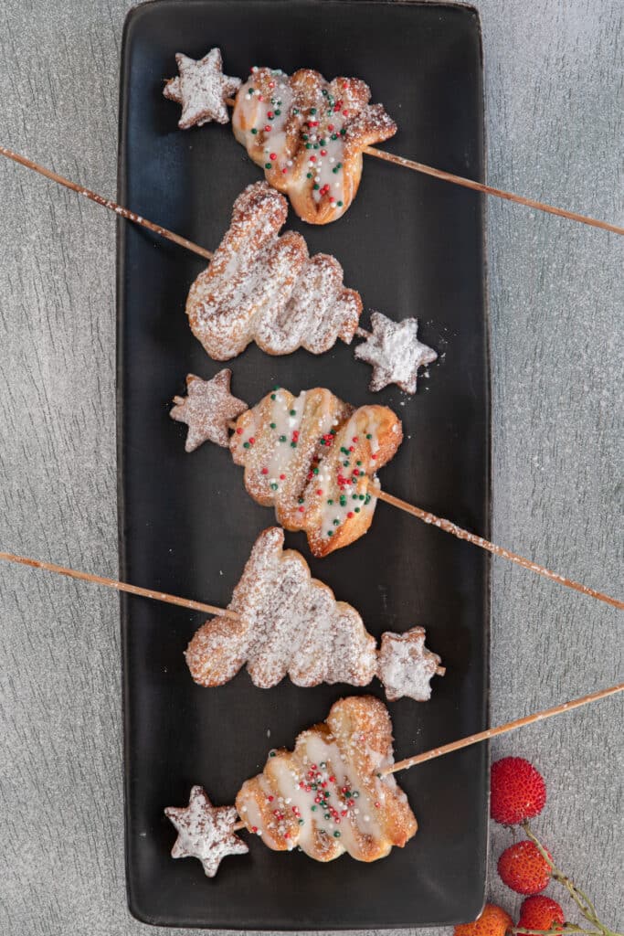 Five trees on a black plate.