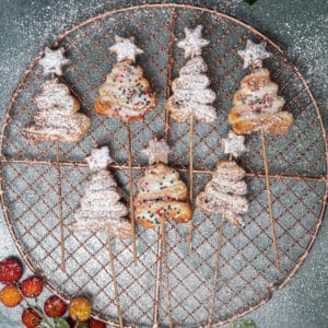 Seven puff pastry Christmas trees on a wire rack.