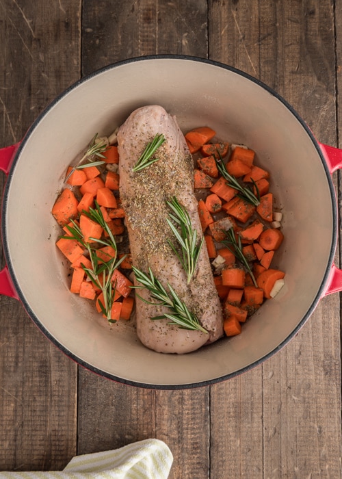 The roast and carrots in the pot.