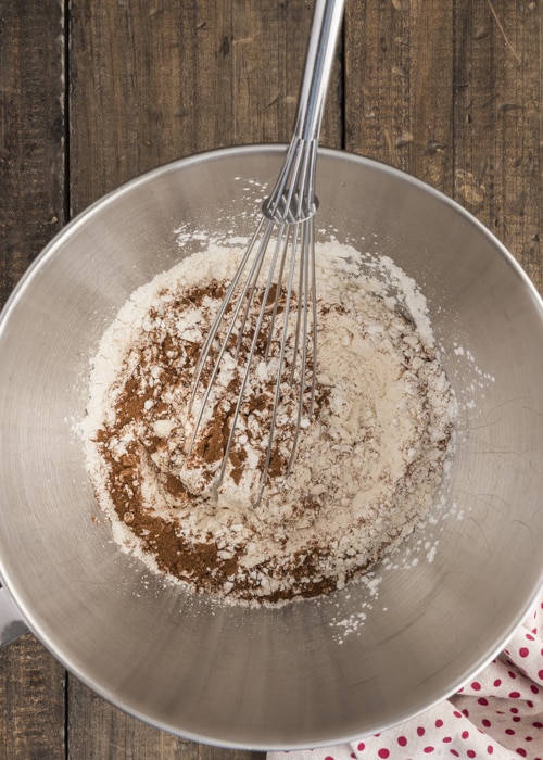 Whisking the dry ingredients in a silver bowl.
