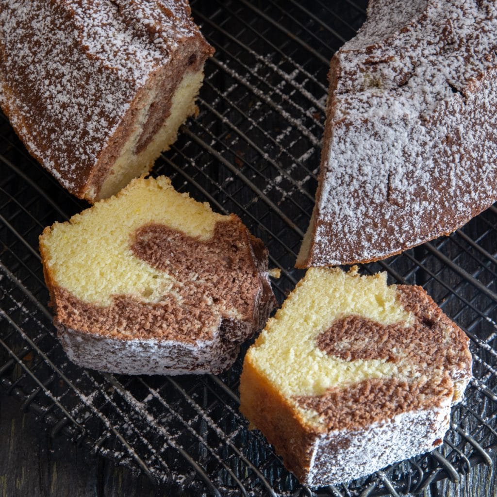 Marble cake with 2 slices cut.