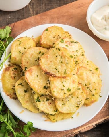 Parmesan potatoes on a white plate.
