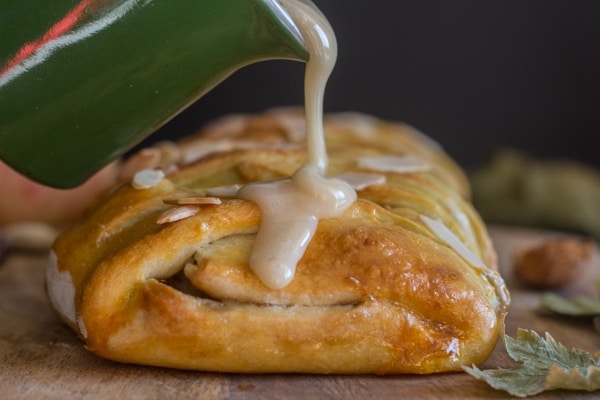 apple strudel with maple glaze being poured