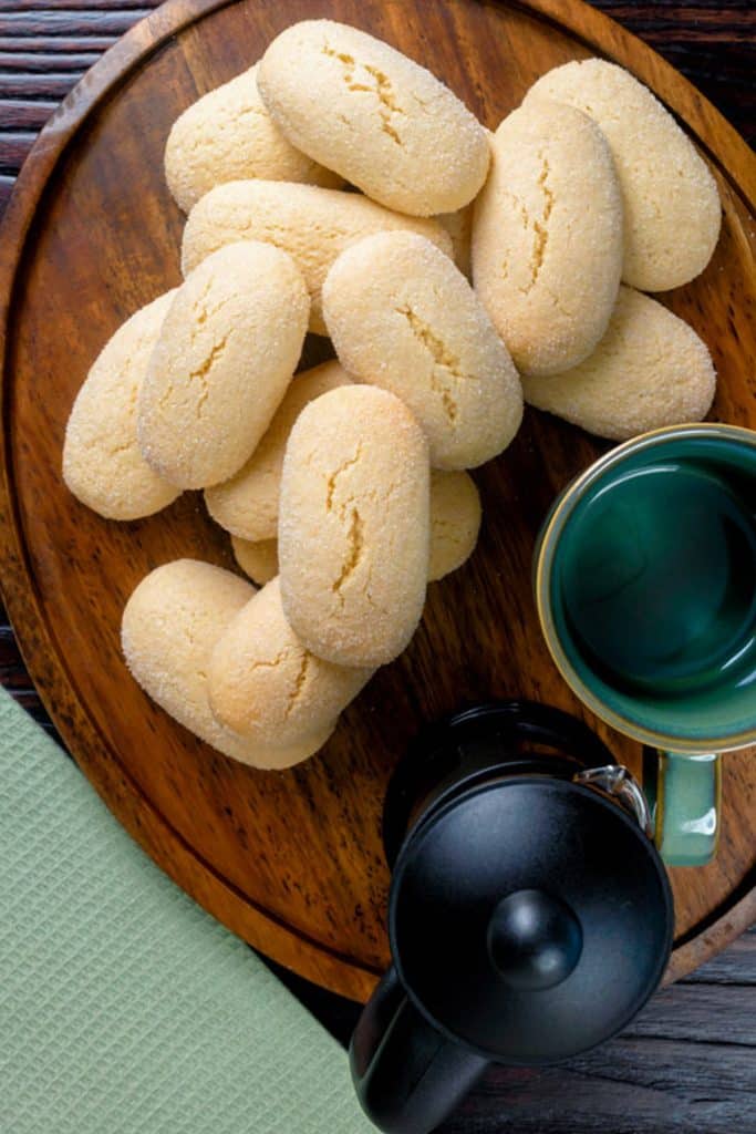 Glass espresso coffee on rustic wooden board, cantucci biscuits