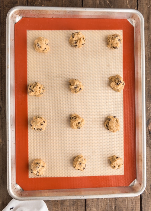 Cookie dough balls on a the baking sheet before baked.
