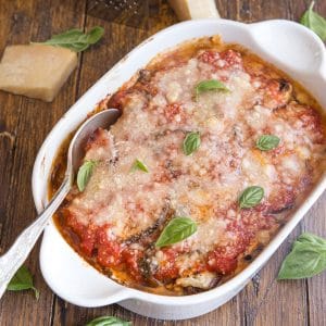 eggplant parmesan baked in a white pan with a silver spoon